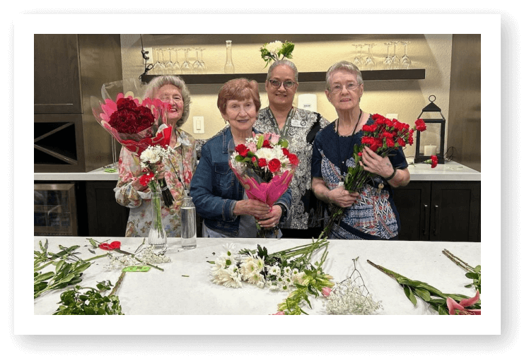 Elderly Women Holding Flower Bouquets During Arrangement Activity at Assisted Living Facility