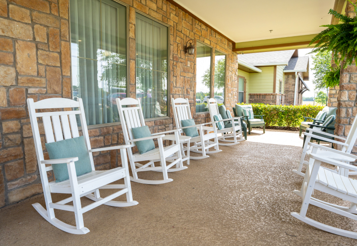 Covered Outdoor Porch Seating Area for Seniors at an Assisted Living Facility Covered Outdoor Porch Seating Area for Seniors at an Assisted Living Facility