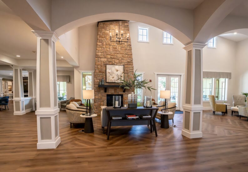 Spacious Lobby with Stone Fireplace for Seniors at Assisted Living Facility Spacious Lobby with Stone Fireplace for Seniors at Assisted Living Facility